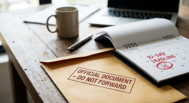 A mail envelope marked Do Not Forward beside a calendar for a USCIS change of address.
